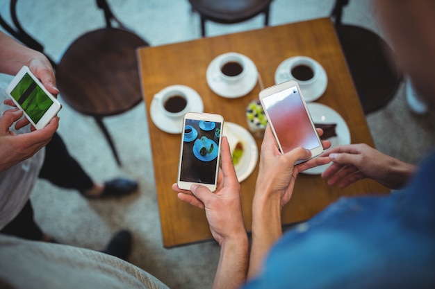 Hands with mobile and coffees background