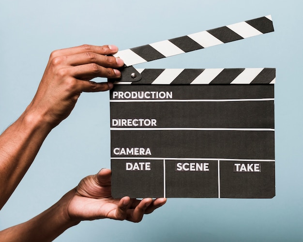 Free photo hands with movie slate