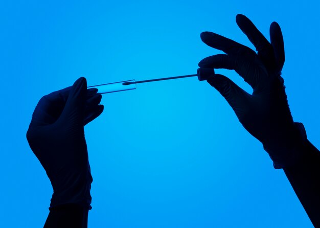 Hands with protective gloves making a covid test