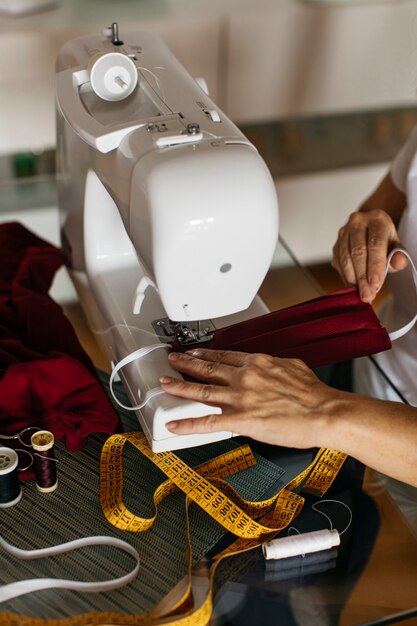 hands of a woman sewing face masks
