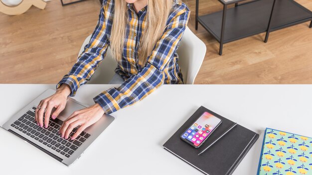 Hands of woman typing on keyboard