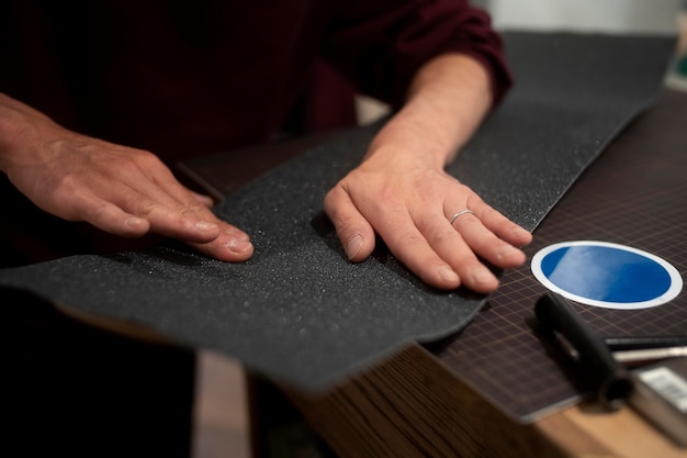 Hands working with grip tape close up