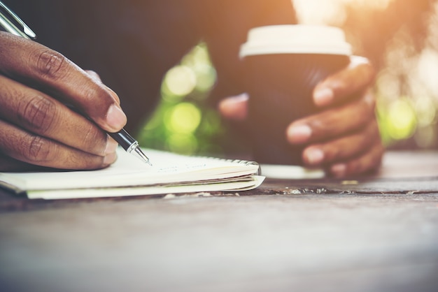 Hands writing on a notebook