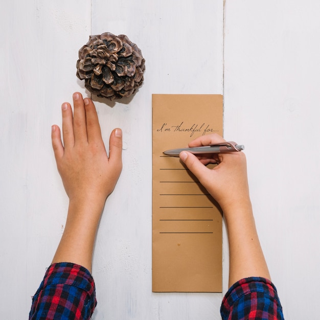 Hands writing on thanksgiving menu