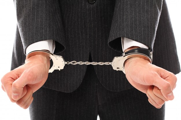 hands of young man in handcuffs