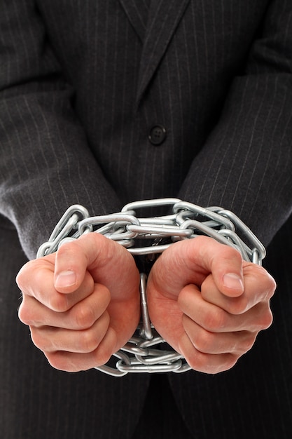 Free photo hands of young man with chains