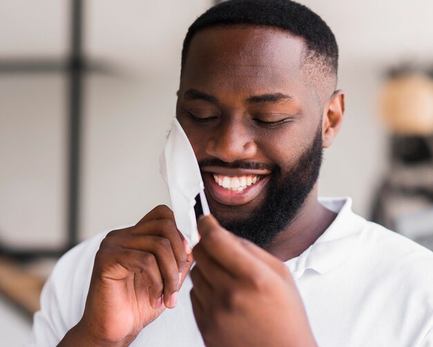 Handsome adult male arranging face mask