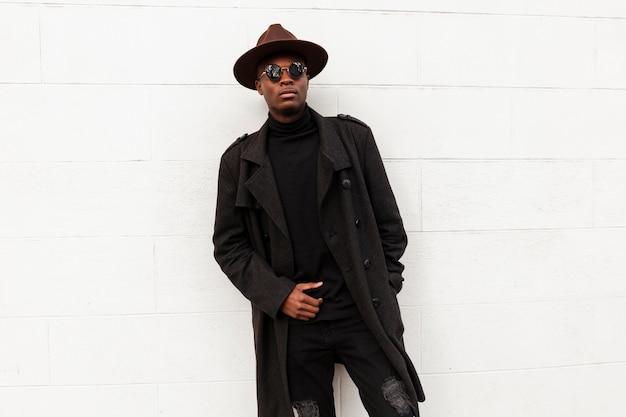 Handsome adult male posing with sunglasses and hat