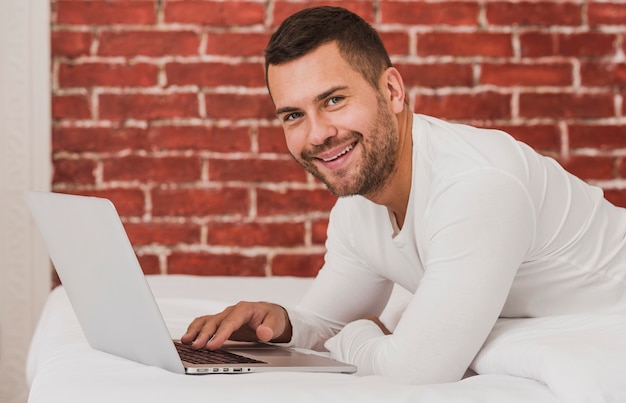 Free photo handsome adult male using a laptop