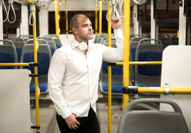 Free photo handsome adult male using public transport