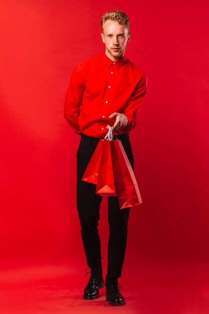 Handsome adult male with shopping bags