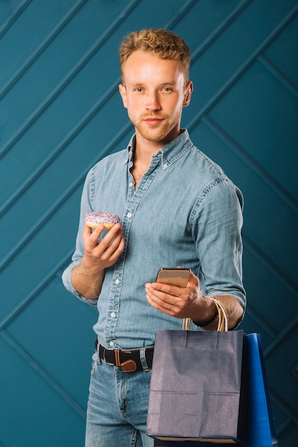 Free photo handsome adult male with shopping bags