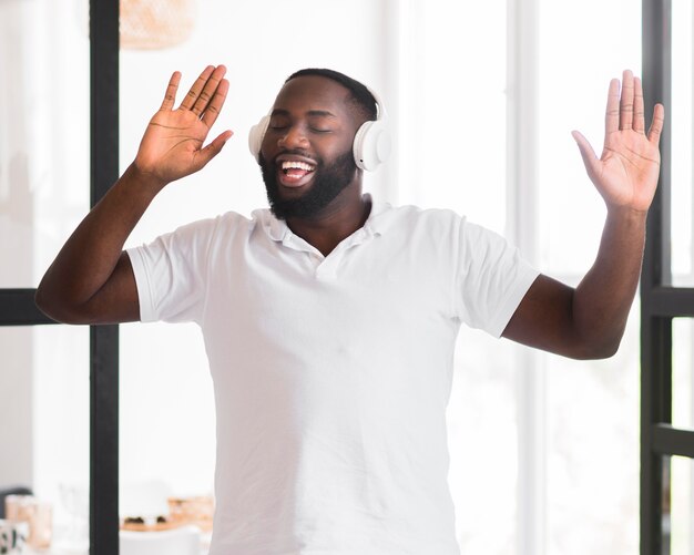 Handsome adult man enjoying music at home