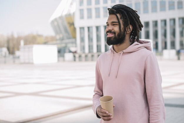 Handsome afroamerican man holding coffee