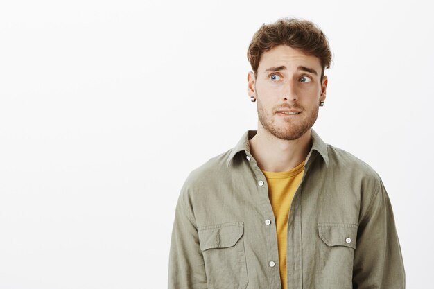 handsome anxious man posing in the studio