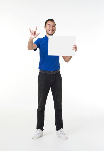 Handsome Asian deliveryman holding mockup blank sign board isola