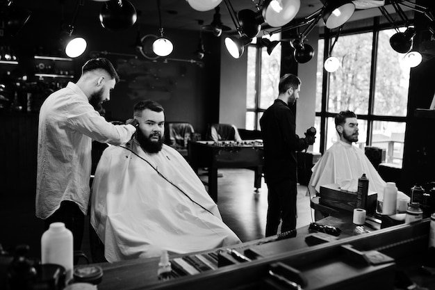 Premium Photo Handsome Bearded Man At The Barbershop Barber At Work