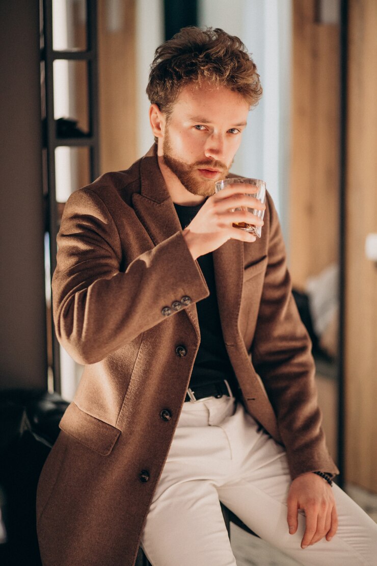 Free Photo handsome bearded man drinking whiskey