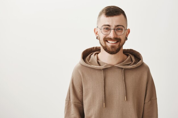 Handsome bearded man in glasses smiling happy