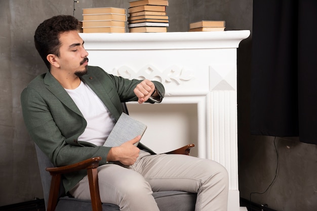 Handsome bearded man reading book.