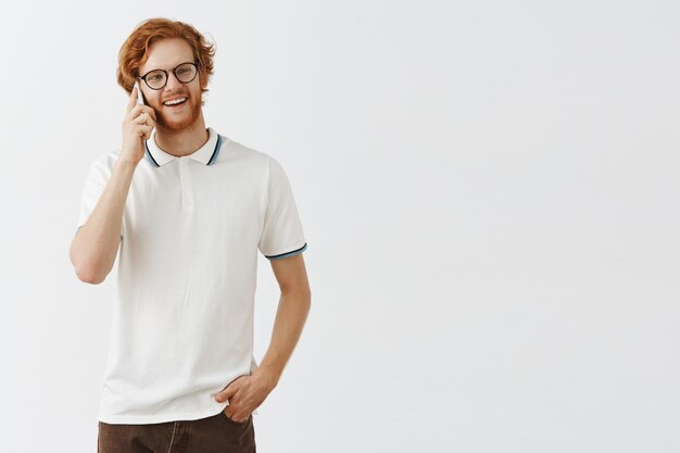 Handsome bearded redhead man talking on phone