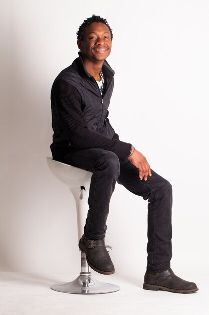 Handsome black guy sitting on a chair