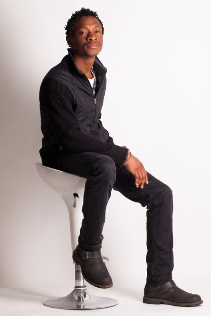 Handsome black guy sitting on a chair