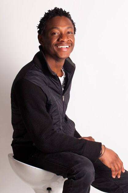 Handsome black guy sitting on a chair