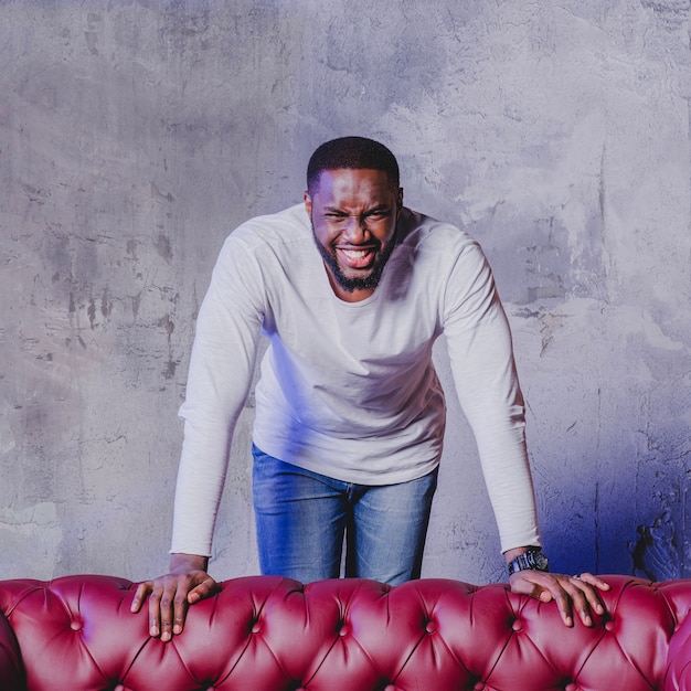 Free photo handsome black man at couch