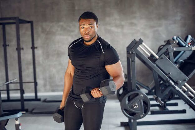 A handsome black man is engaged in a gym