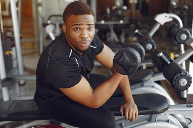 A handsome black man is engaged in a gym