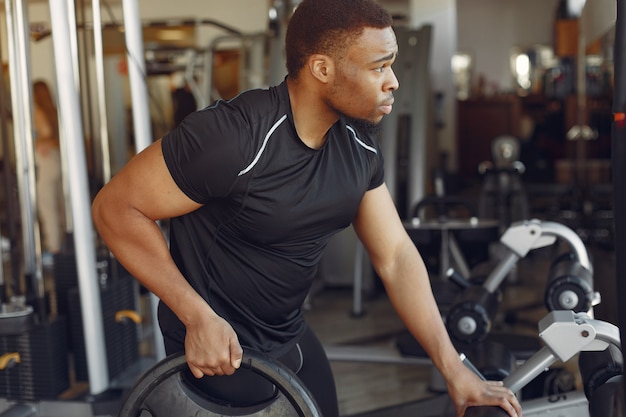 Free Photo | A handsome black man is engaged in a gym