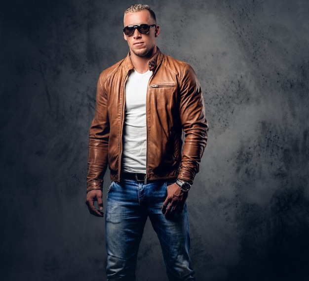 Free Photo | Handsome Blond, Muscular Male In Sunglasses, Dressed In A White  T Shirt And Brown Leather Jacket.