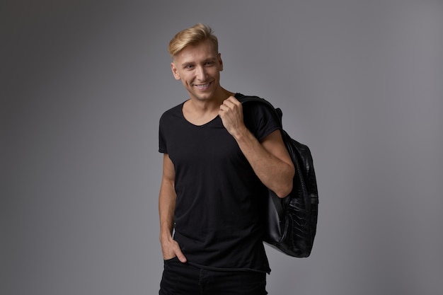 Free photo handsome blond young man posing at studio