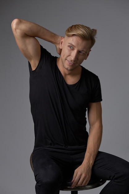 Free photo handsome blond young man posing