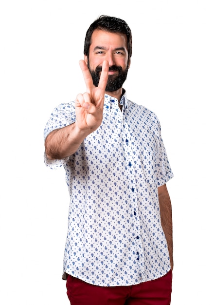 Handsome brunette man with beard counting two