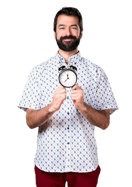 Free photo handsome brunette man with beard holding vintage clock