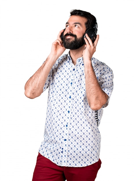 Handsome brunette man with beard listening music