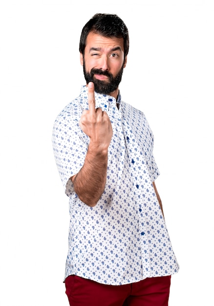 Handsome brunette man with beard making horn gesture