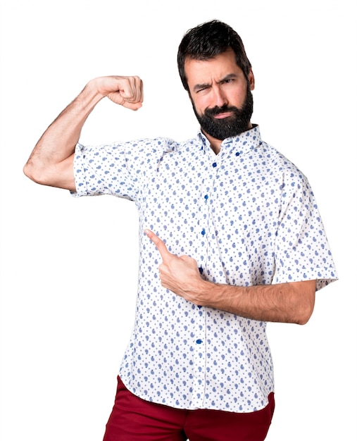 Handsome brunette man with beard making strong gesture