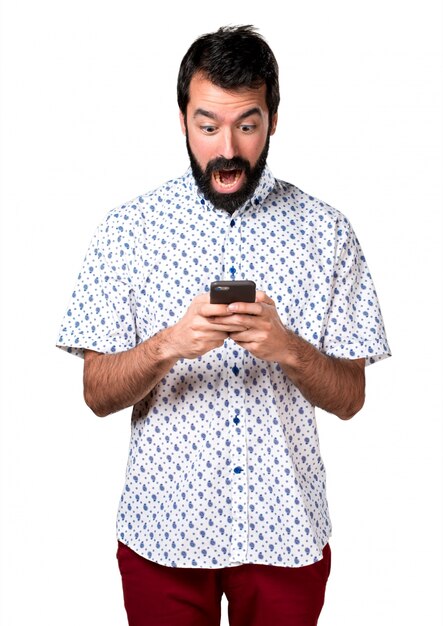 Handsome brunette man with beard talking to mobile