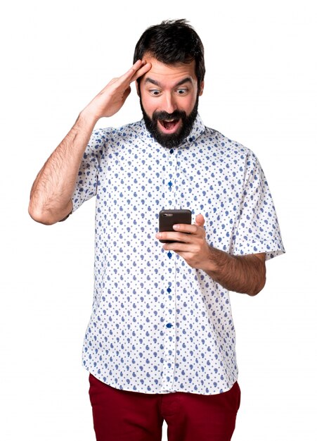 Handsome brunette man with beard talking to mobile