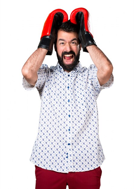 Handsome brunette man with beard with boxing gloves