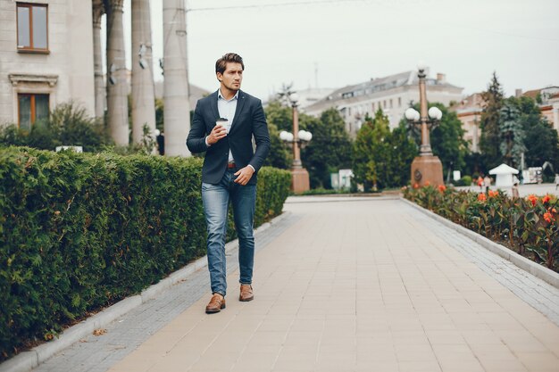 Handsome businesman in a summer city