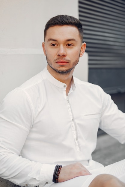 Handsome businesman in a summer city