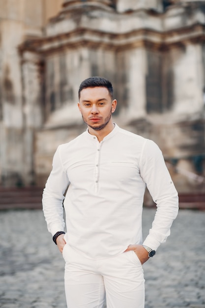 Handsome businesman in a summer city