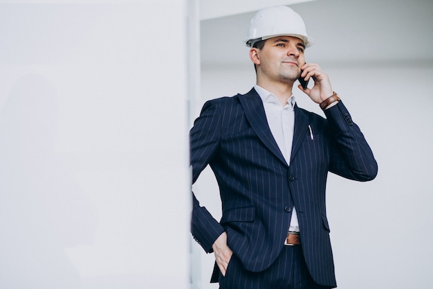 Handsome business man engineer in hard hat in a building