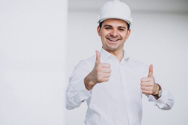 Handsome business man engineer in hard hat in a building