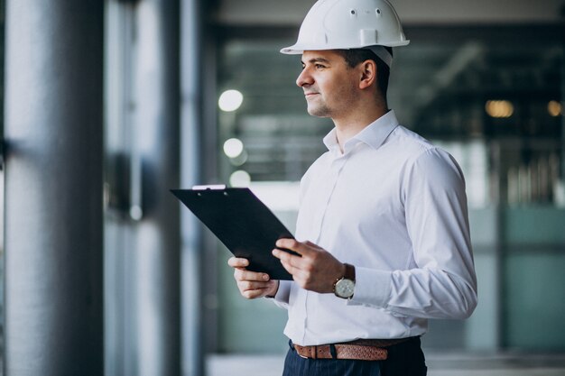 handsome business man engineer in hard hat in a building