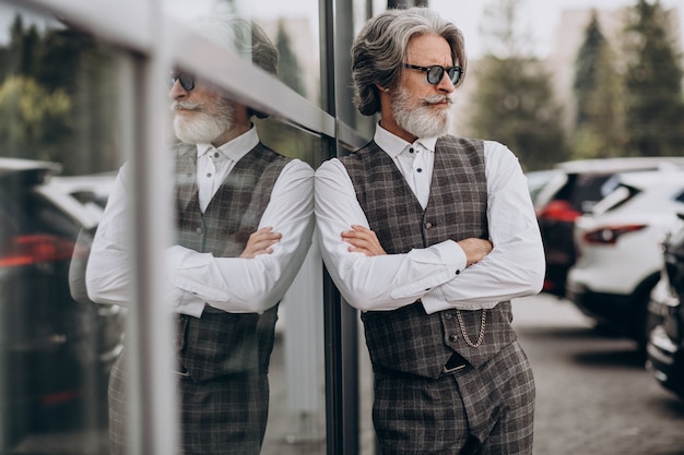 Handsome business man standing outside and thinking